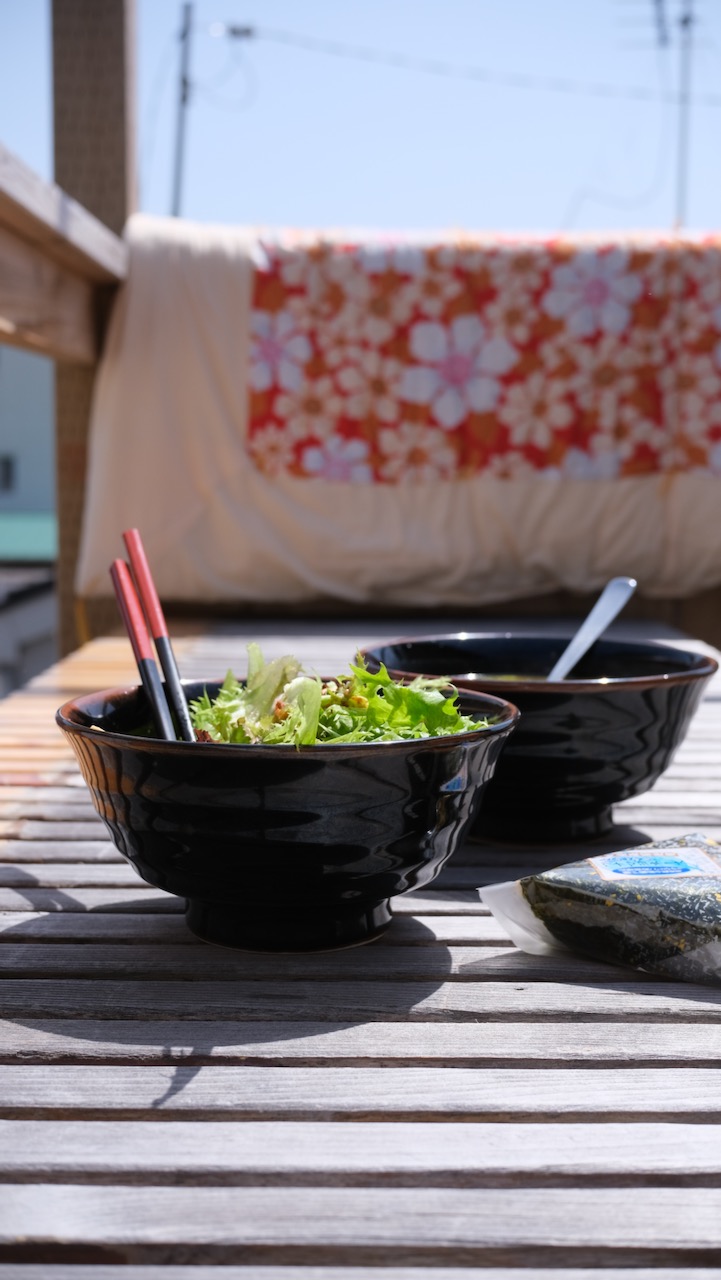 food on the terrace between futons drying in the sun