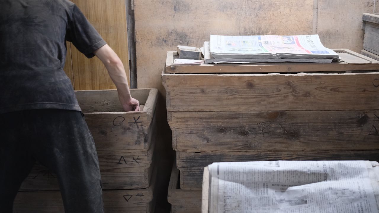 man covering sticks with ashes